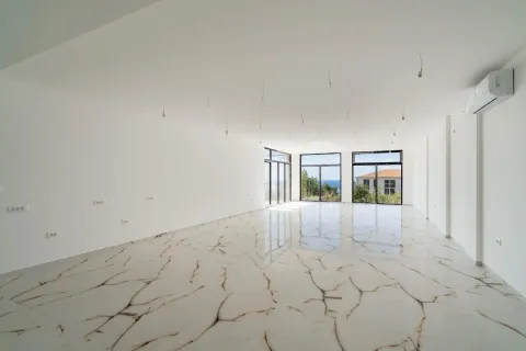 Spacious empty room with bright marble flooring and large windows overlooking the sea. - image 12