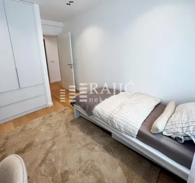 Smaller bedroom with a bed and a built-in wardrobe. - image 10