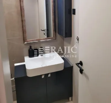 Smaller bathroom with a washbasin and a mirror. - image 12