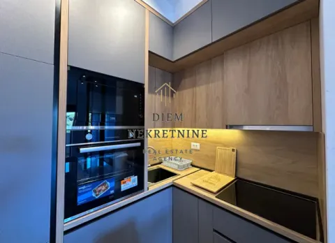 Modern kitchen with built-in appliances and wooden and grey cabinetry. - image 6