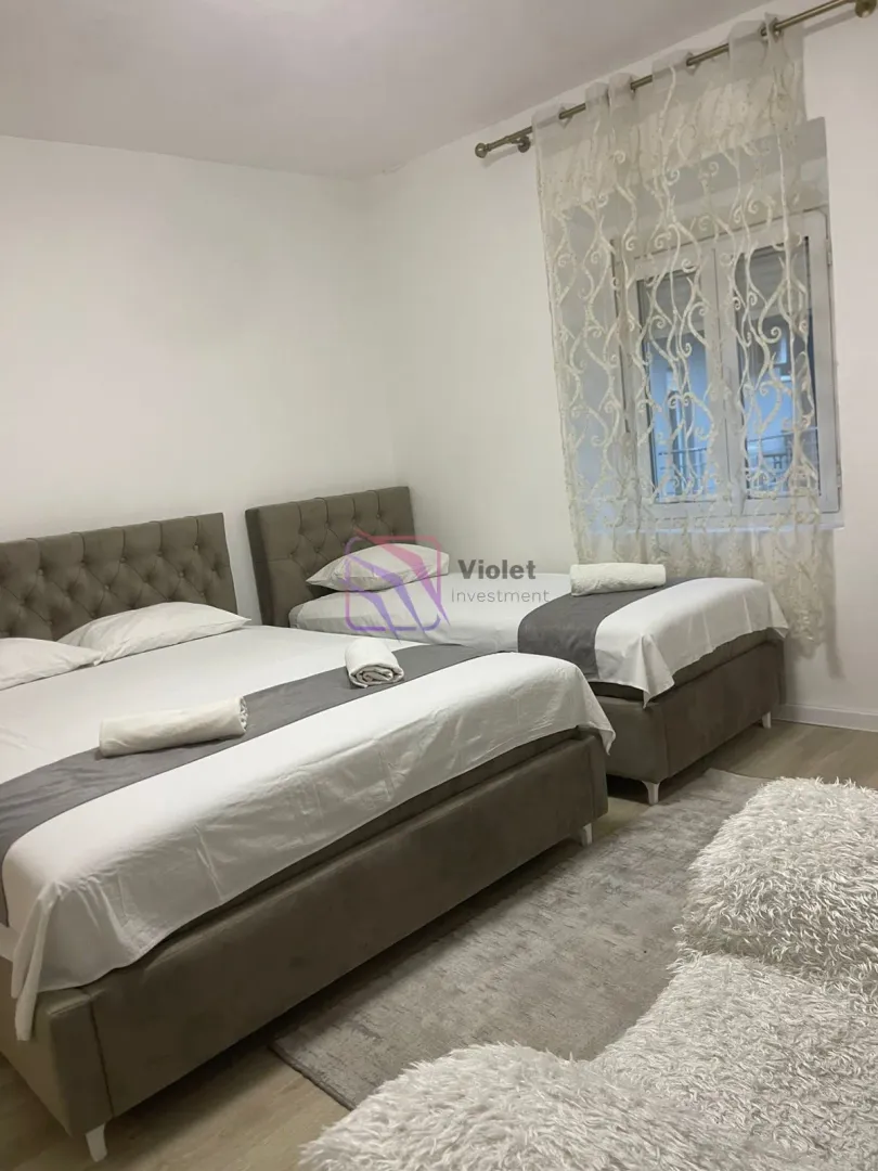 Bedroom with two beds and a window.