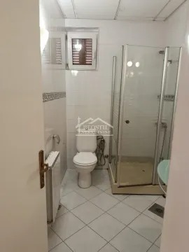Bathroom with a shower cabin and a toilet. - image 18