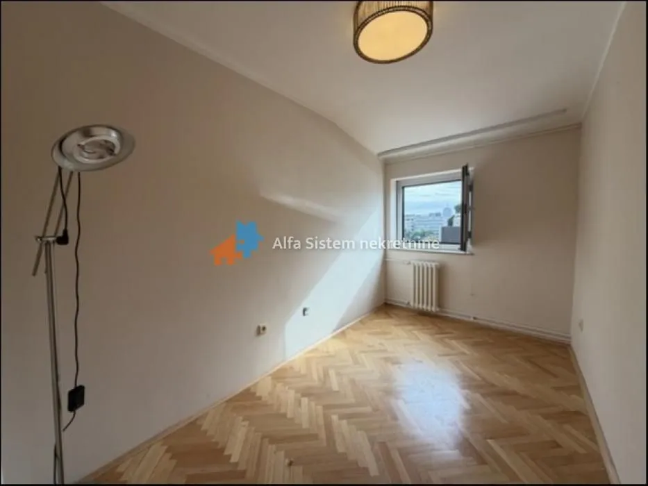 Empty room with hardwood floors and a window.