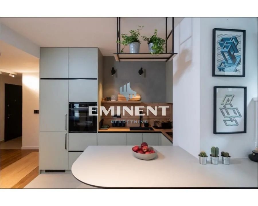 Modern kitchen with built-in appliances and a breakfast bar.