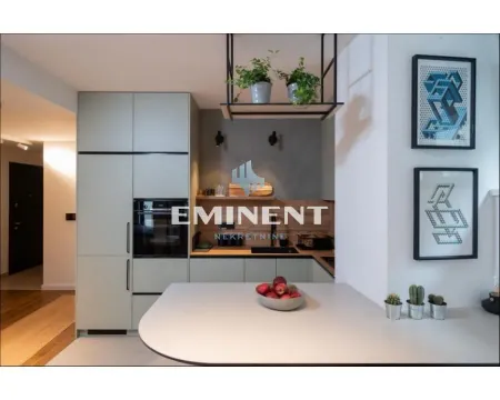 Modern kitchen with built-in appliances and a breakfast bar. - image 6