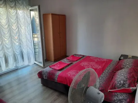 Bedroom with a double bed, wardrobe, and access to the terrace. - image 9