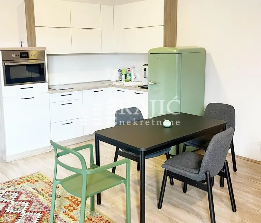 Bright kitchen with dining area and a retro refrigerator.
