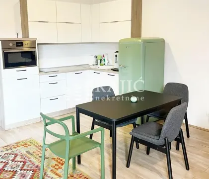 Bright kitchen with dining area and a retro refrigerator. - image 4