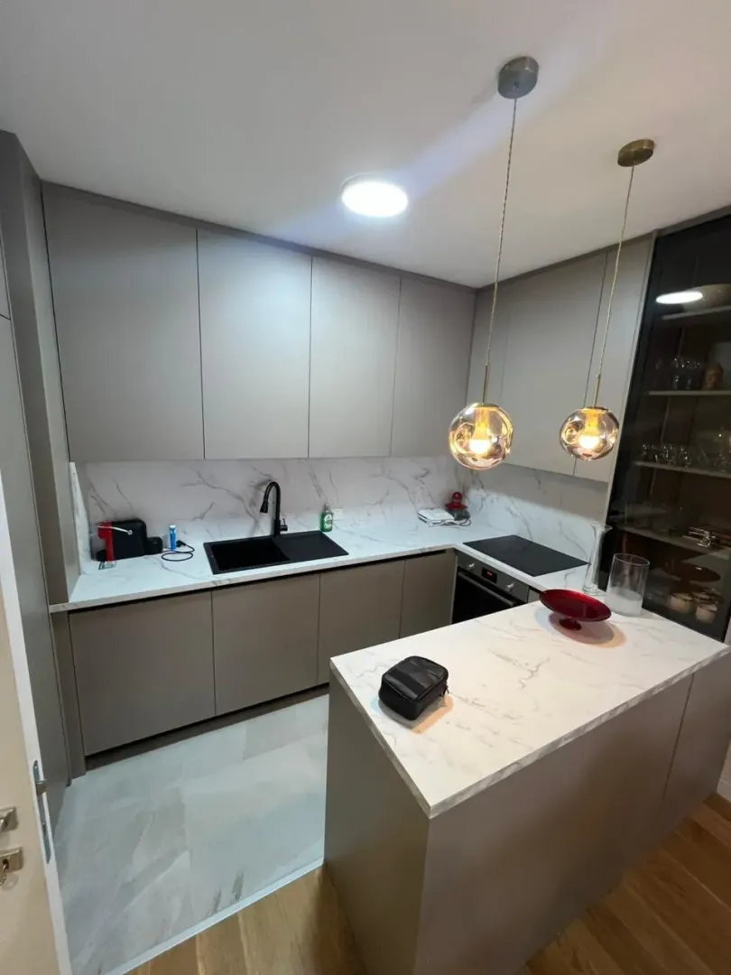 Modern kitchen with built-in appliances and a kitchen island.