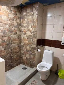 Bathroom with a walk-in shower and a toilet. - image 13