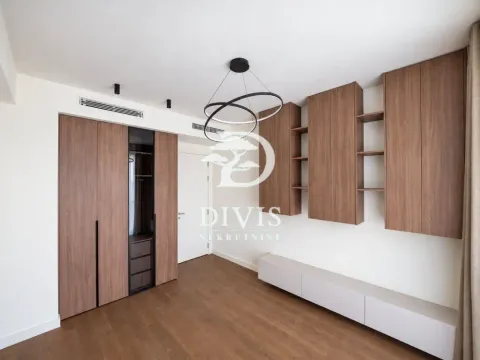 Modern bedroom with built-in wardrobes and wooden flooring. - image 14