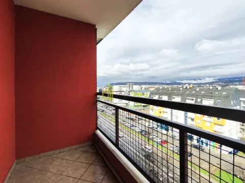 Covered balcony with a view of the city and surrounding buildings. - image 13