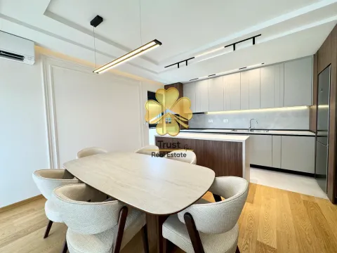 Modern kitchen with a dining area and built-in appliances. - image 3