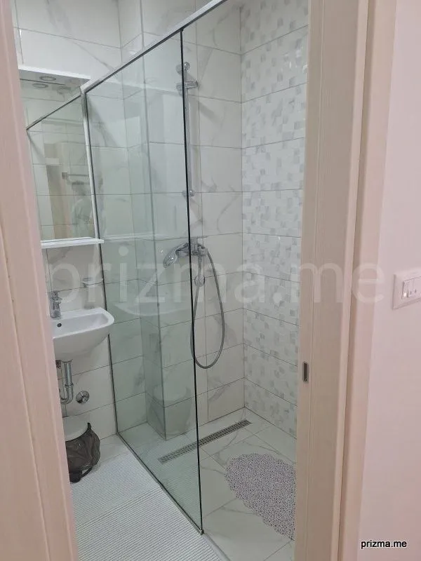 Small bathroom with a walk-in shower and washbasin.