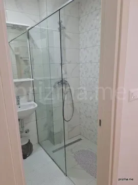 Small bathroom with a walk-in shower and washbasin. - image 6
