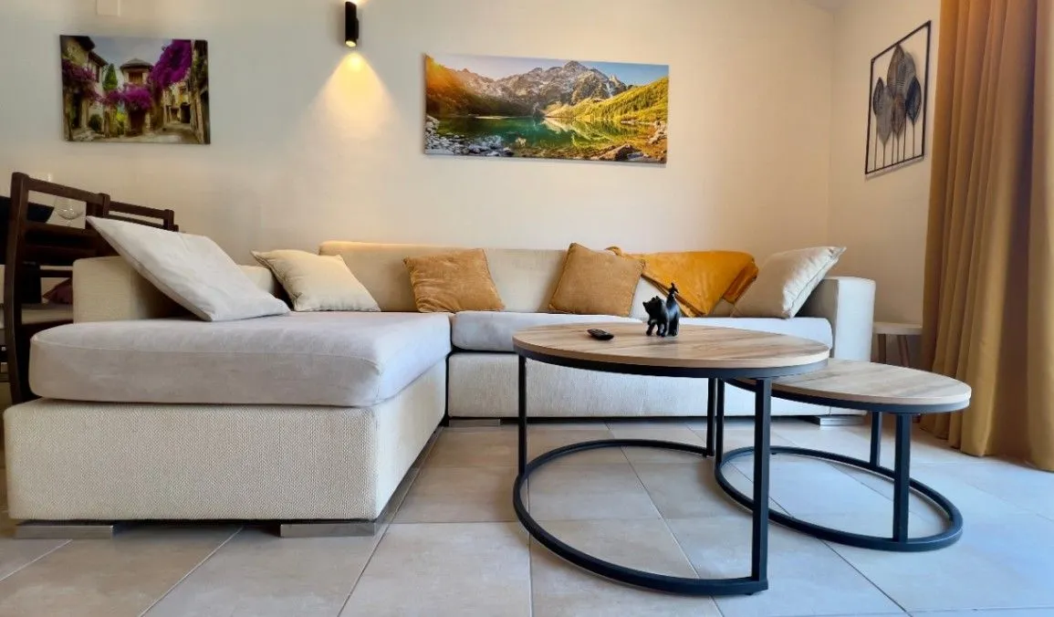 Comfortable living room with a sectional sofa and a round coffee table.