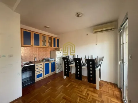 Kitchen with dining area and wooden cabinets. - image 2