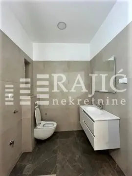 Modern equipped bathroom with a washbasin and toilet. - image 2