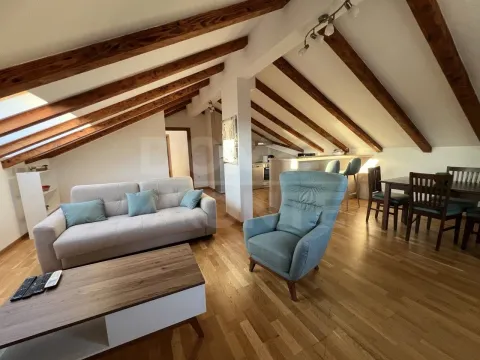 Spacious living room with wooden ceiling beams and a dining area. - image 9