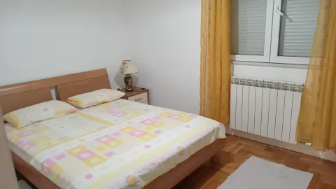 Bright bedroom with a double bed and yellow curtains. - image 5