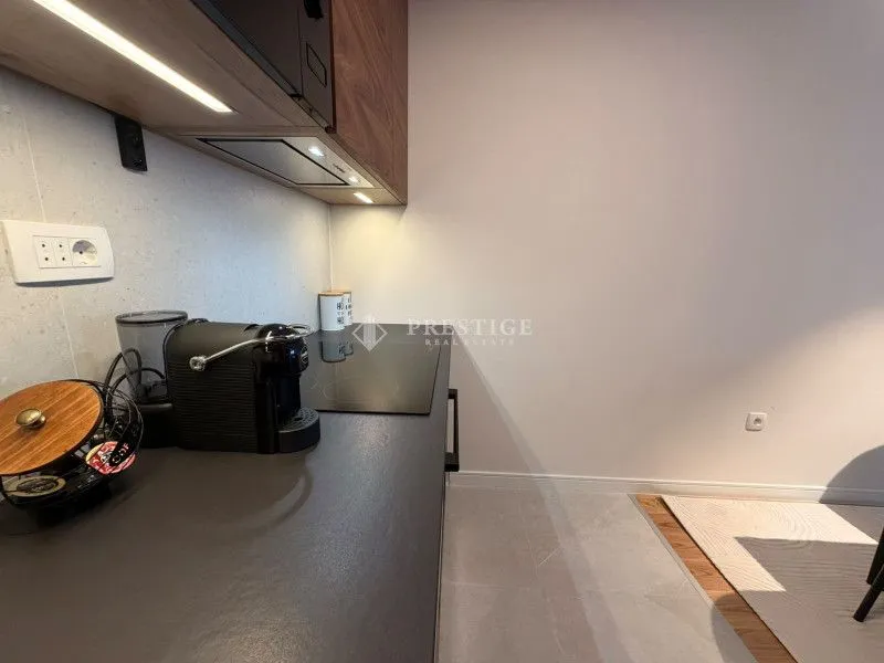 Modern kitchen with dark countertops and built-in appliances.