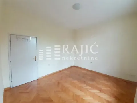 Empty room with parquet flooring and white walls. - image 14