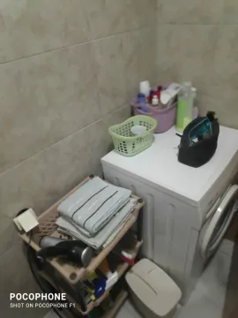 Part of a bathroom with a washing machine and a shelf. - image 7