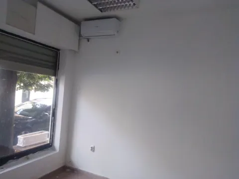 An empty interior space with white walls and an air conditioner. - image 2