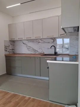 Modern kitchen with grey cabinets and a marble backsplash. - image 7