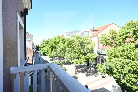 View from the balcony overlooking the street and trees. - image 20