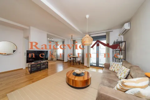 Spacious living room with a sofa, wooden coffee table, and TV. - image 20