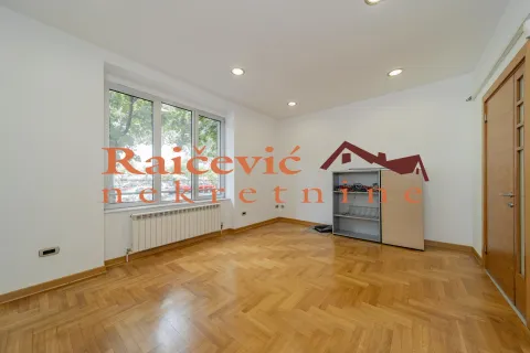 Empty room with hardwood parquet flooring and a large window. - image 6
