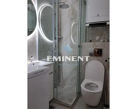 Modernly equipped bathroom with a shower cabin and built-in fixtures. - image 3