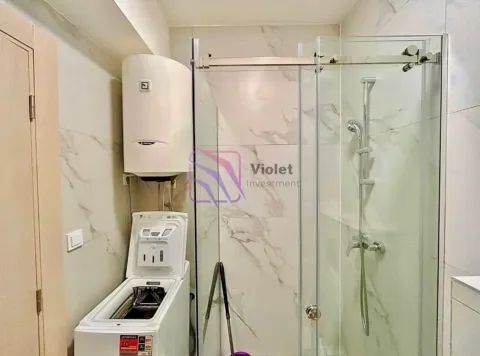 Bathroom with a shower cabin, water heater, and washing machine. - image 3