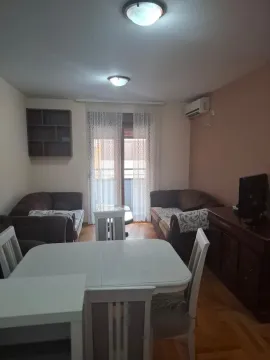 Living room with a sofa set, dining table, and balcony access. - image 7