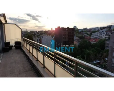 Spacious balcony with outdoor seating and city views. - image 14