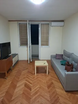 Living room with a grey sofa, television and access to the terrace. - image 7