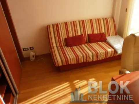 Living room with a sofa bed and hardwood flooring. - image 3