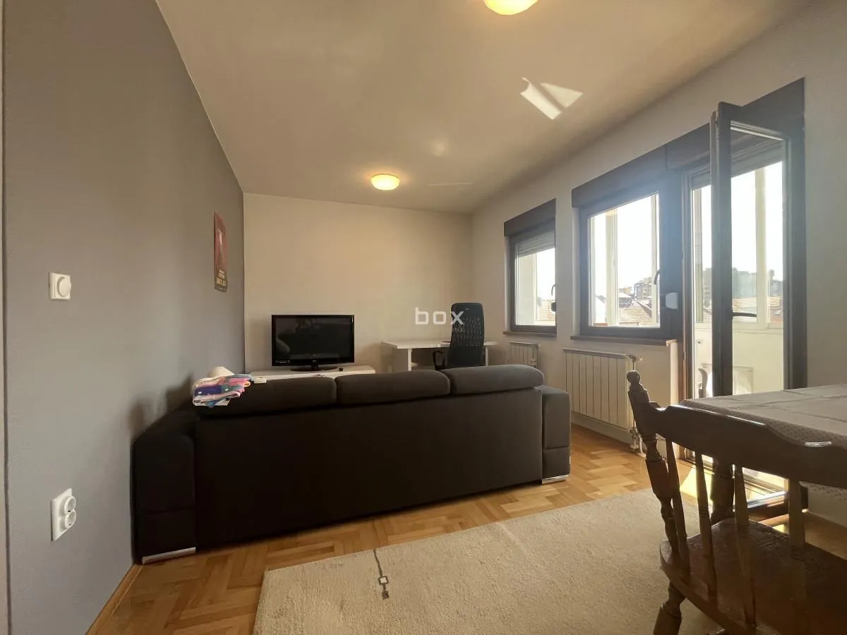 Living room with a sofa and access to the terrace.