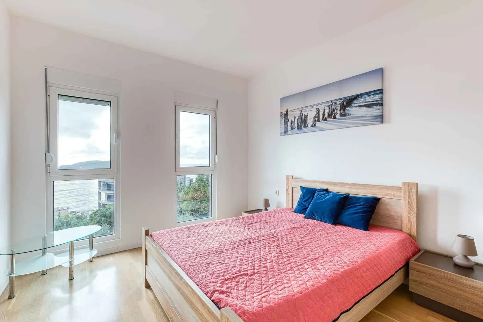 Bright bedroom with a double bed and sea view.