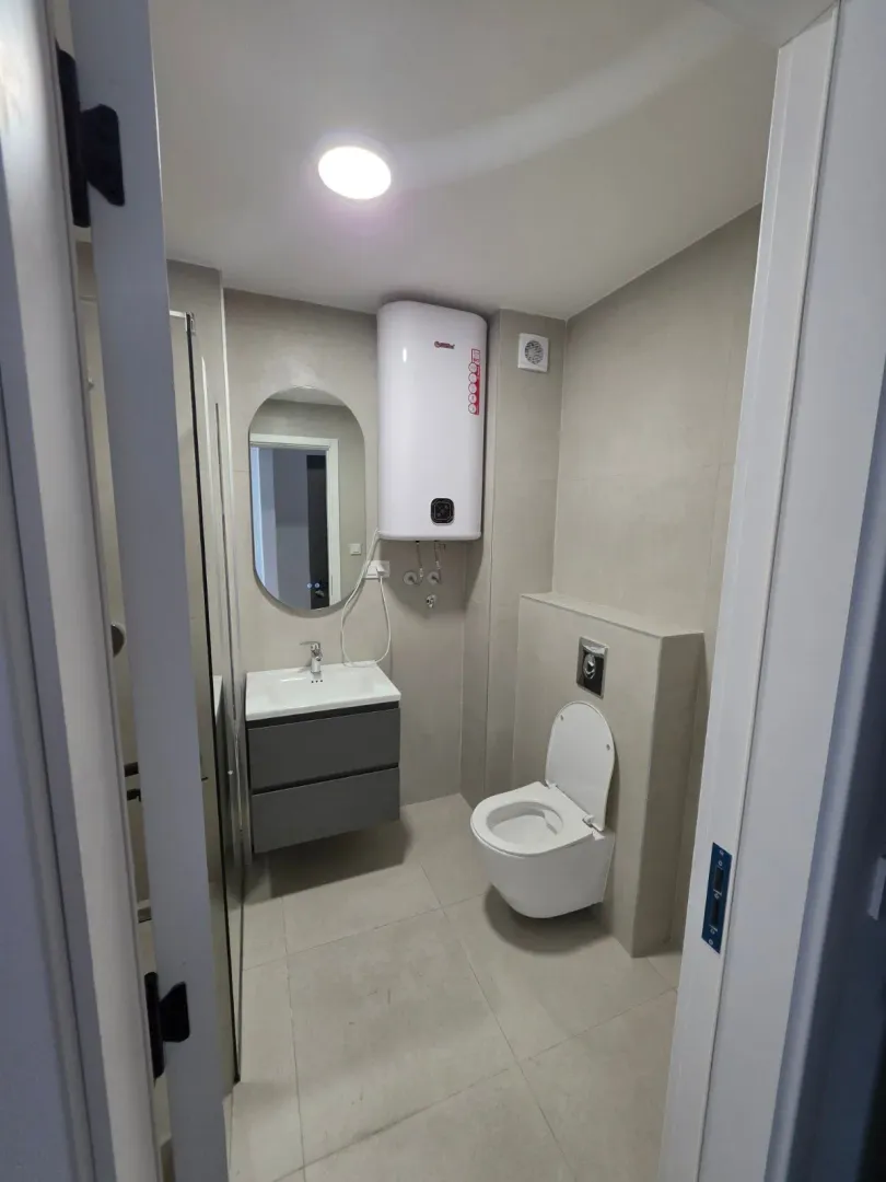 Moderne opremljeno kupatilo sa tuš kabinom i bojl.