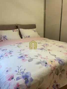 Furnished bedroom with a double bed and a wardrobe. - image 15