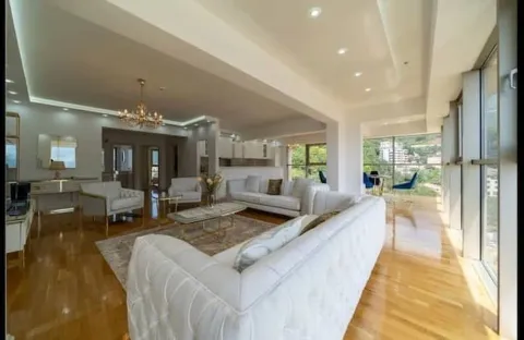 Spacious living room with seating area and large glass surfaces. - image 5