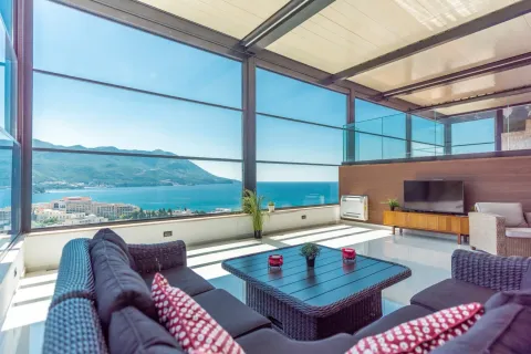 Enclosed terrace with outdoor seating and a beautiful view of the sea and mountains. - image 3