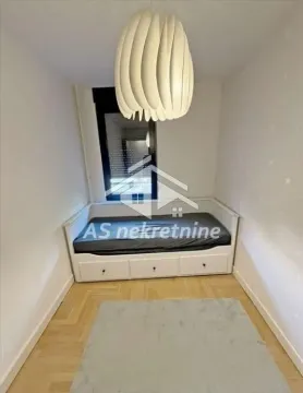 Small bedroom with a pull-out bed and a chandelier. - image 15