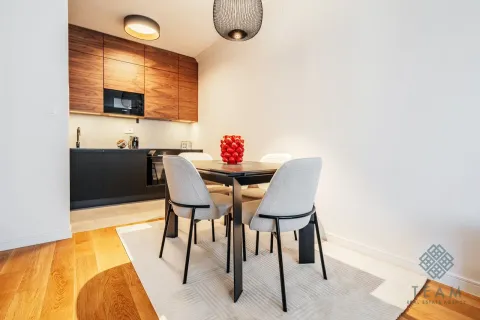 Dining area with a modern table and chairs situated next to the kitchen. - image 6
