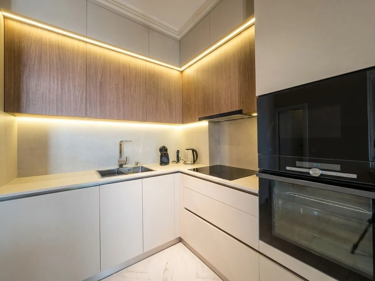 Modern kitchen with built-in appliances and LED lighting.