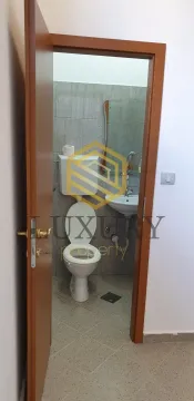 View through an open door into a small bathroom with sanitary fixtures. - image 3
