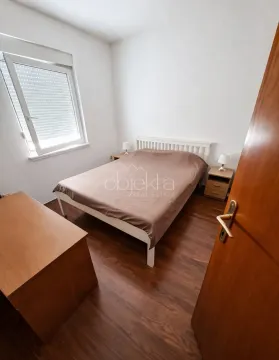Furnished bedroom with a double bed, bedside tables, and a window. - image 10