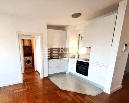 White kitchen with built-in appliances in the apartment. - image 3